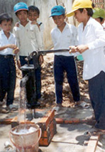 Boys at the water pump